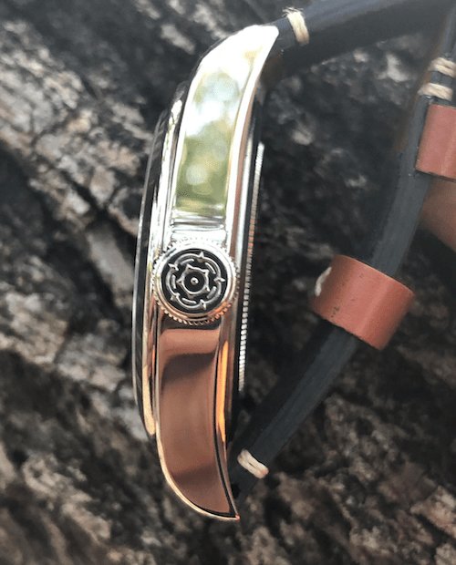 The enrgaved Tudor rose logo stands proud on the crown